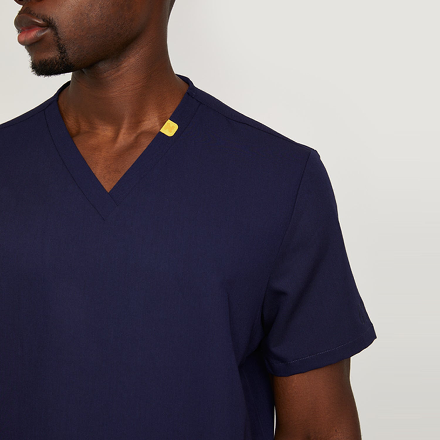 Nimbs medical scrubs in navy dark blue, available in the UK, featuring our signature yellow tag for healthcare professionals.