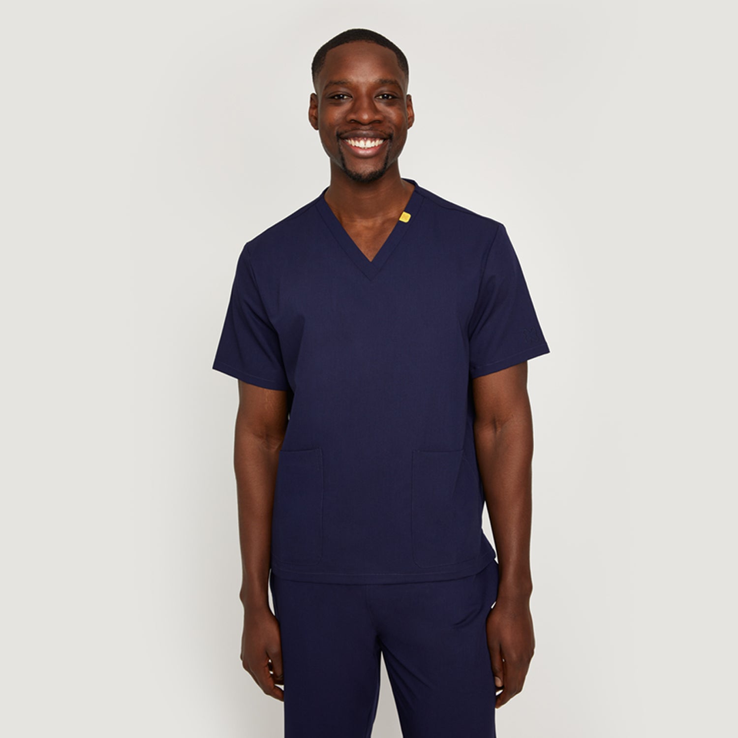 Nimbs medical scrubs in navy dark blue, available in the UK, featuring our signature yellow tag for healthcare professionals.