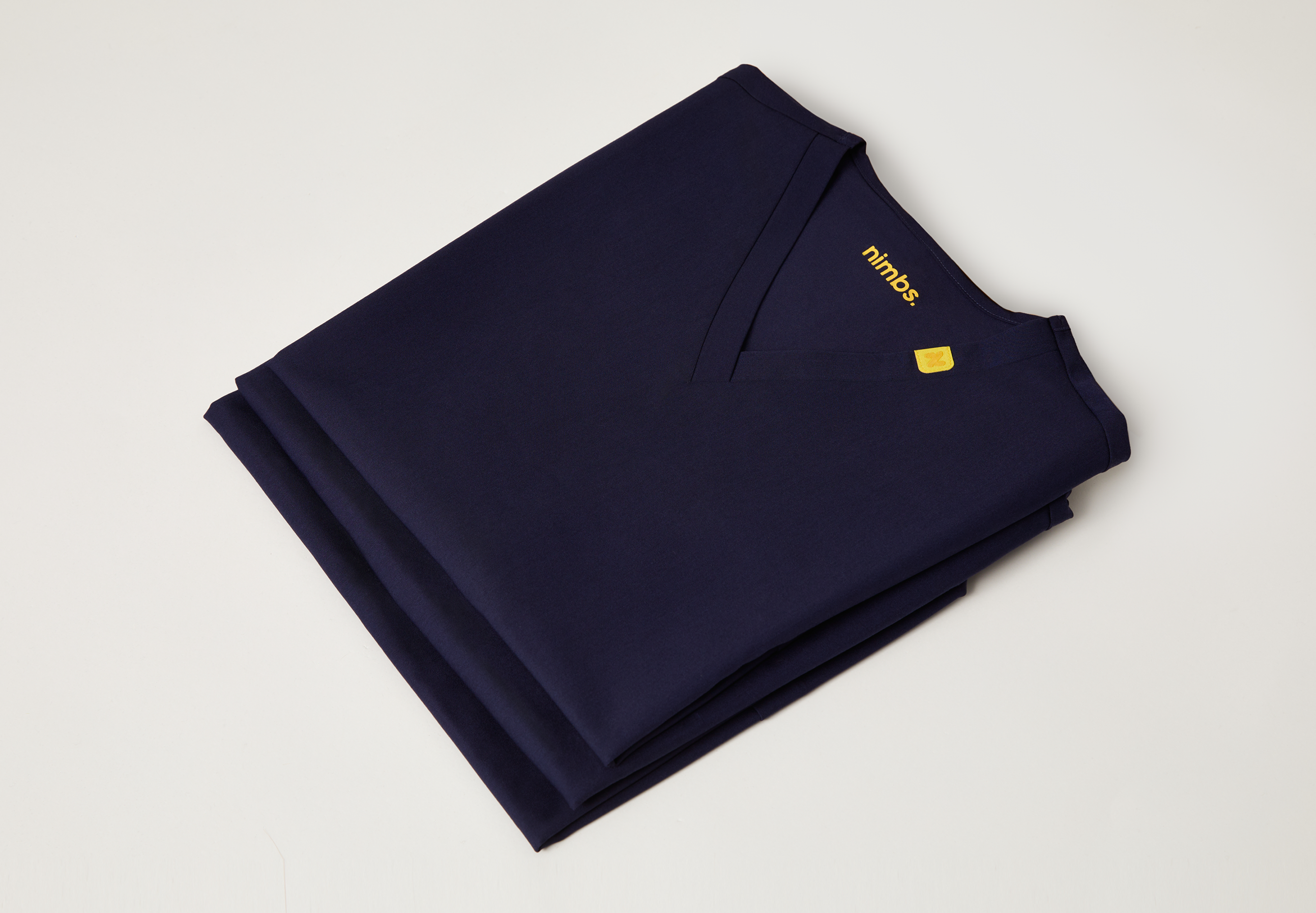 Nimbs medical scrubs in navy dark blue, available in the UK, featuring our signature yellow tag for healthcare professionals.